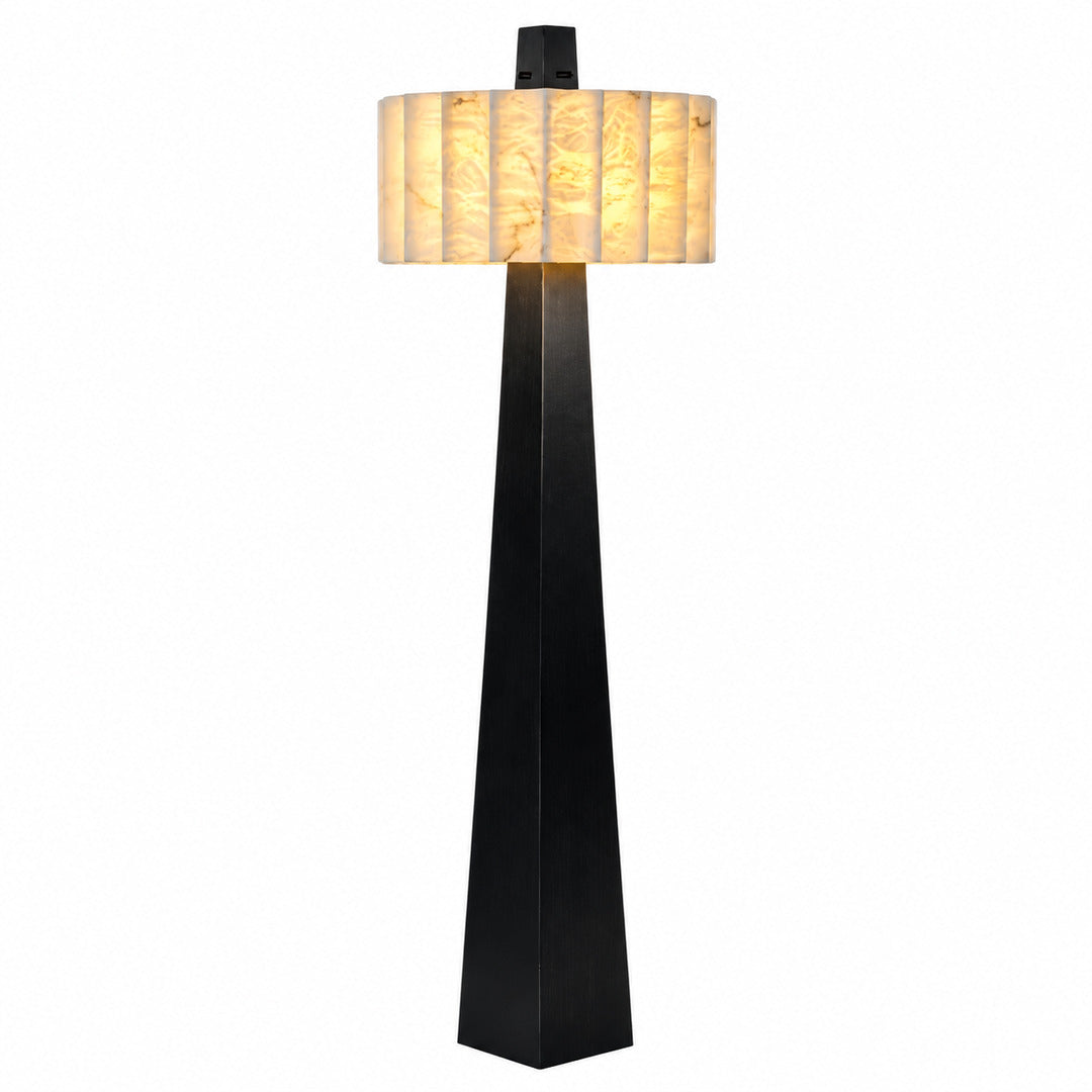 Guglia modern alabaster floor lamp with a tapered black obelisk base and glowing alabaster shade in a living room