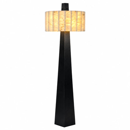 Guglia modern alabaster floor lamp with a tapered black obelisk base and glowing alabaster shade in a living room