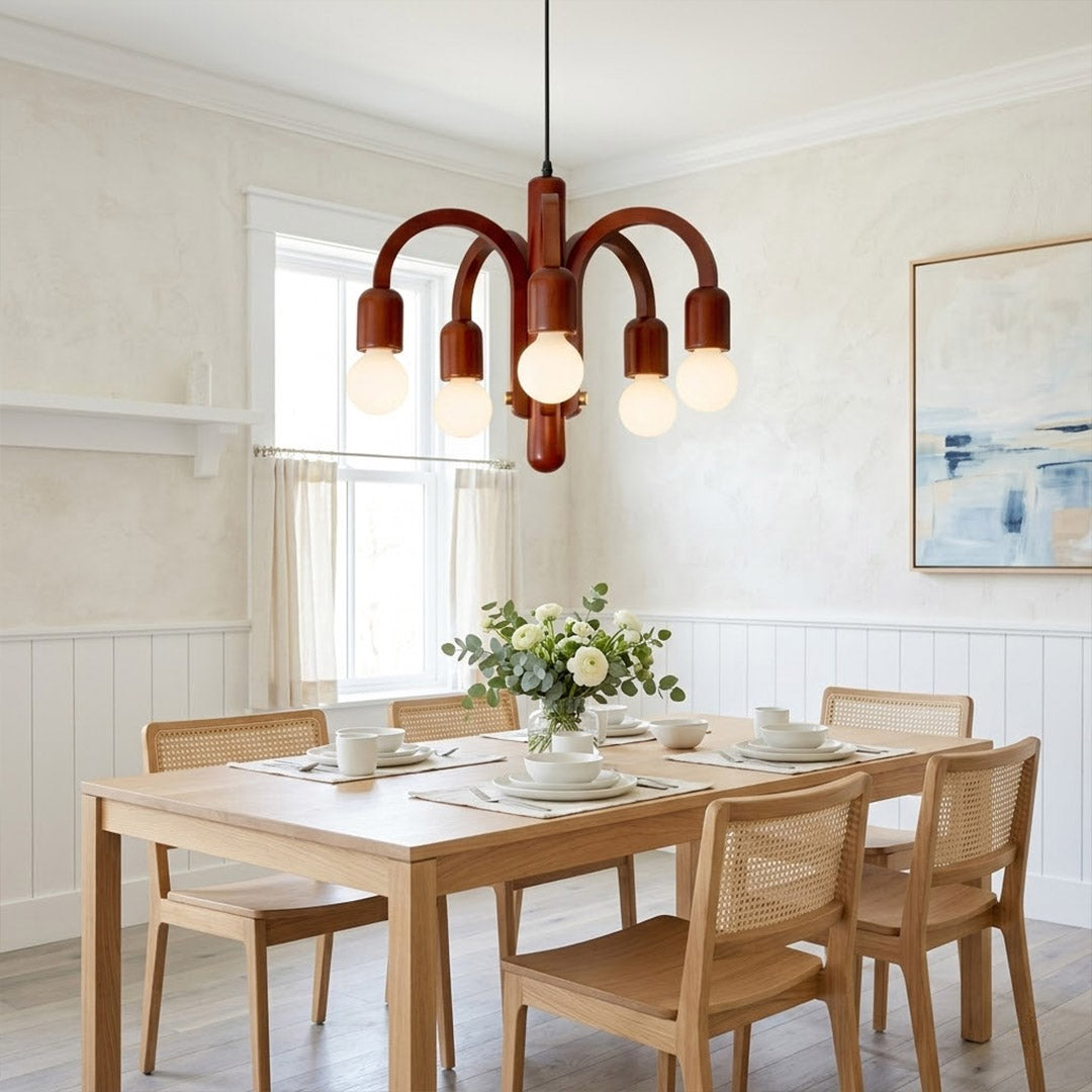 Hadley Model A walnut wood chandelier above Mid Century dining table Eames era furnishings retro modernist interior warm glow