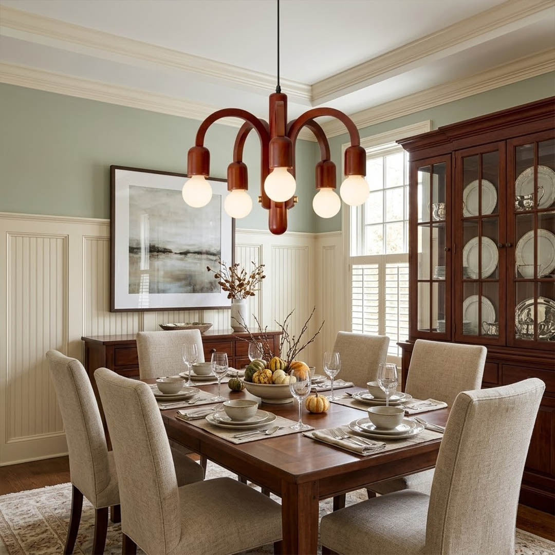 Hadley Model A walnut wood chandelier above Mid Century dining table Eames era furnishings retro modernist interior warm glow