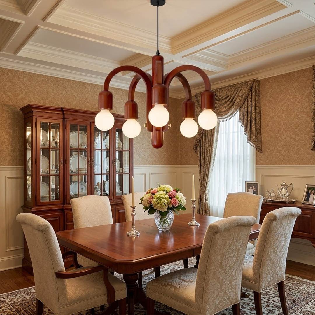 Hadley Model A walnut wood chandelier above Mid Century dining table Eames era furnishings retro modernist interior warm glow