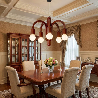 Hadley Model A walnut wood chandelier above Mid Century dining table Eames era furnishings retro modernist interior warm glow