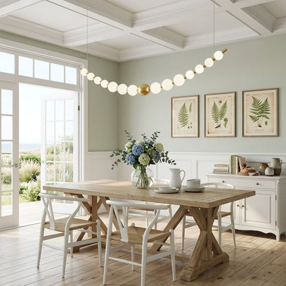 Halia pearl ring chandelier above round dining table elegant warm glow modern interior

