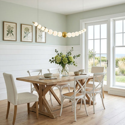 Halia pearl ring chandelier above round dining table elegant warm glow modern interior
