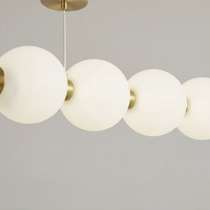 Halia chandelier brass ring frame pearl finished acrylic globes detail close up