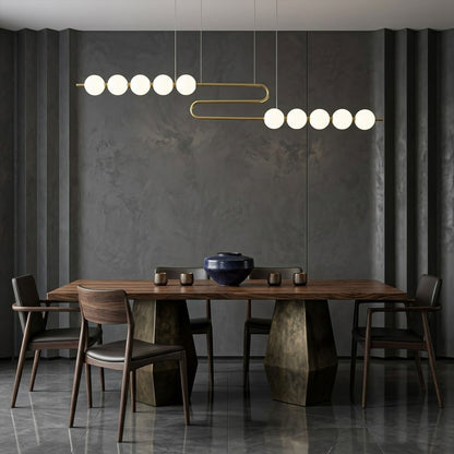 Halia pearl ring chandelier above round dining table elegant warm glow modern interior
