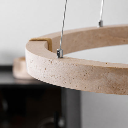 Halo travertine pendant light illuminated warm light glowing through stone veining amber honey detail close up