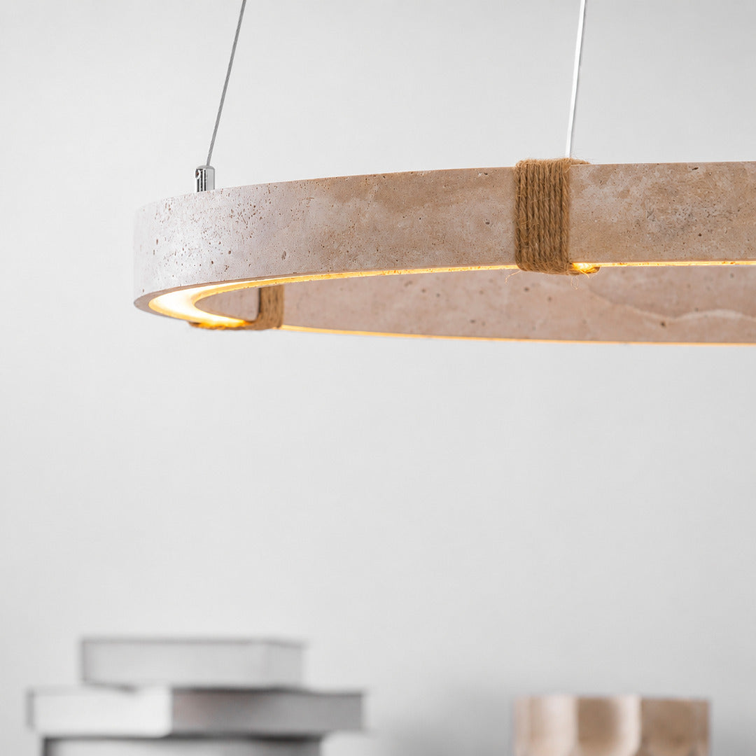 Halo travertine pendant light illuminated warm light glowing through stone veining amber honey detail close up