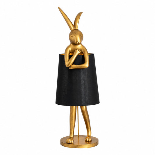 Hare silhouette table lamp with a golden long-eared hare sculpture beside a white shade glowing warm