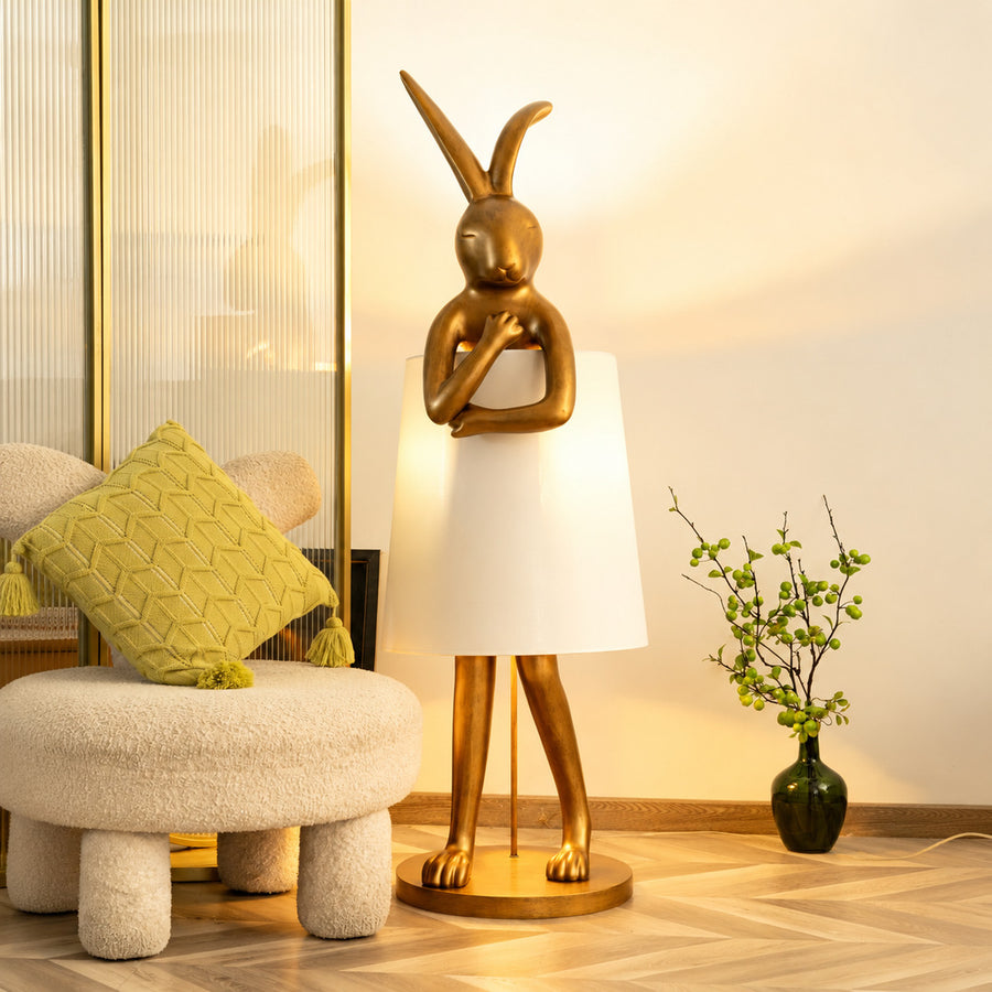 Hare silhouette table lamp casting a warm glow in a cozy corner reading nook