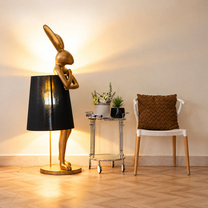 Hare silhouette table lamp casting a warm glow in a cozy corner reading nook