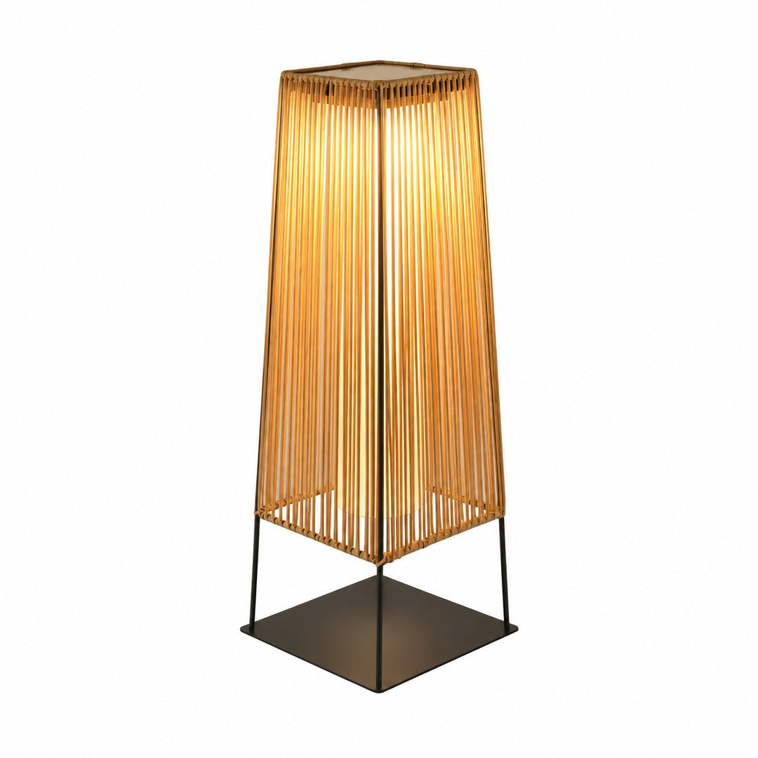 Intreccio outdoor post light with a woven rattan-style body glowing warm on a garden path