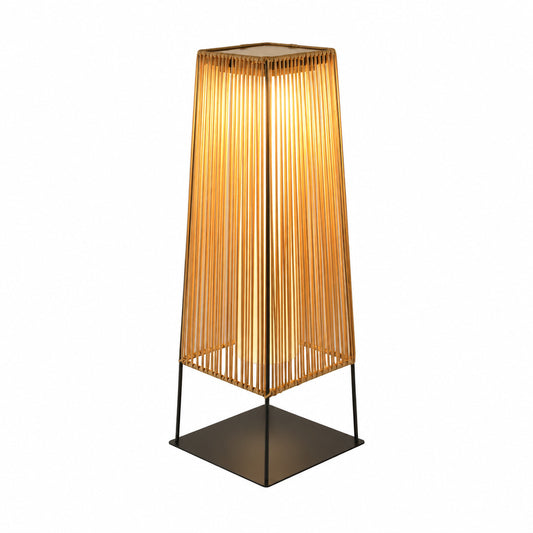 Intreccio outdoor post light with a woven rattan-style body glowing warm on a garden path