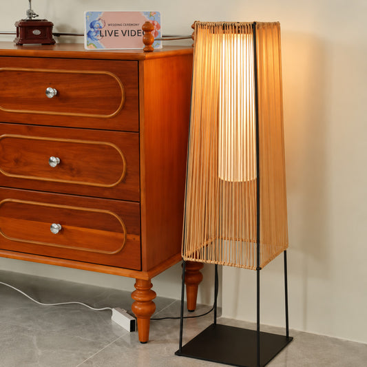 Intreccio woven outdoor post light anchoring a warm bohemian garden setup