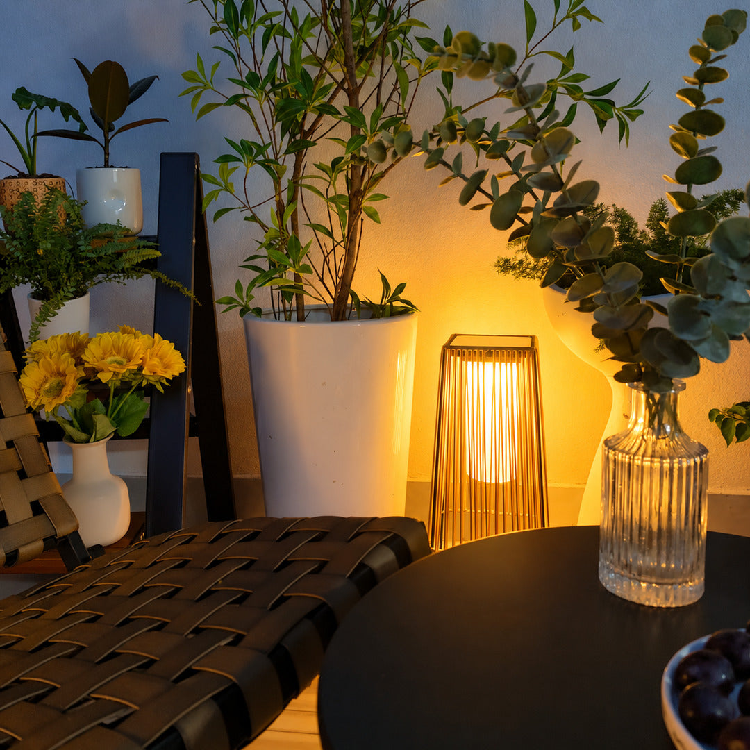 Intreccio outdoor post lights lining a garden bed with a warm woven glow at dusk