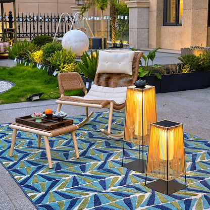 Pair of Intreccio outdoor post lights framing a front entrance with warm woven light