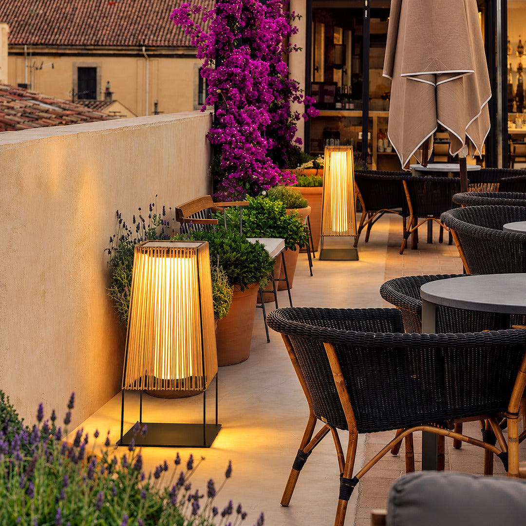 Intreccio outdoor post lights lighting a bed and breakfast courtyard with woven light