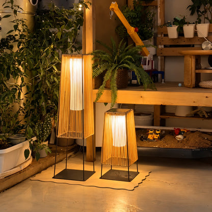 Intreccio outdoor post light adding a cozy woven glow to a small balcony corner