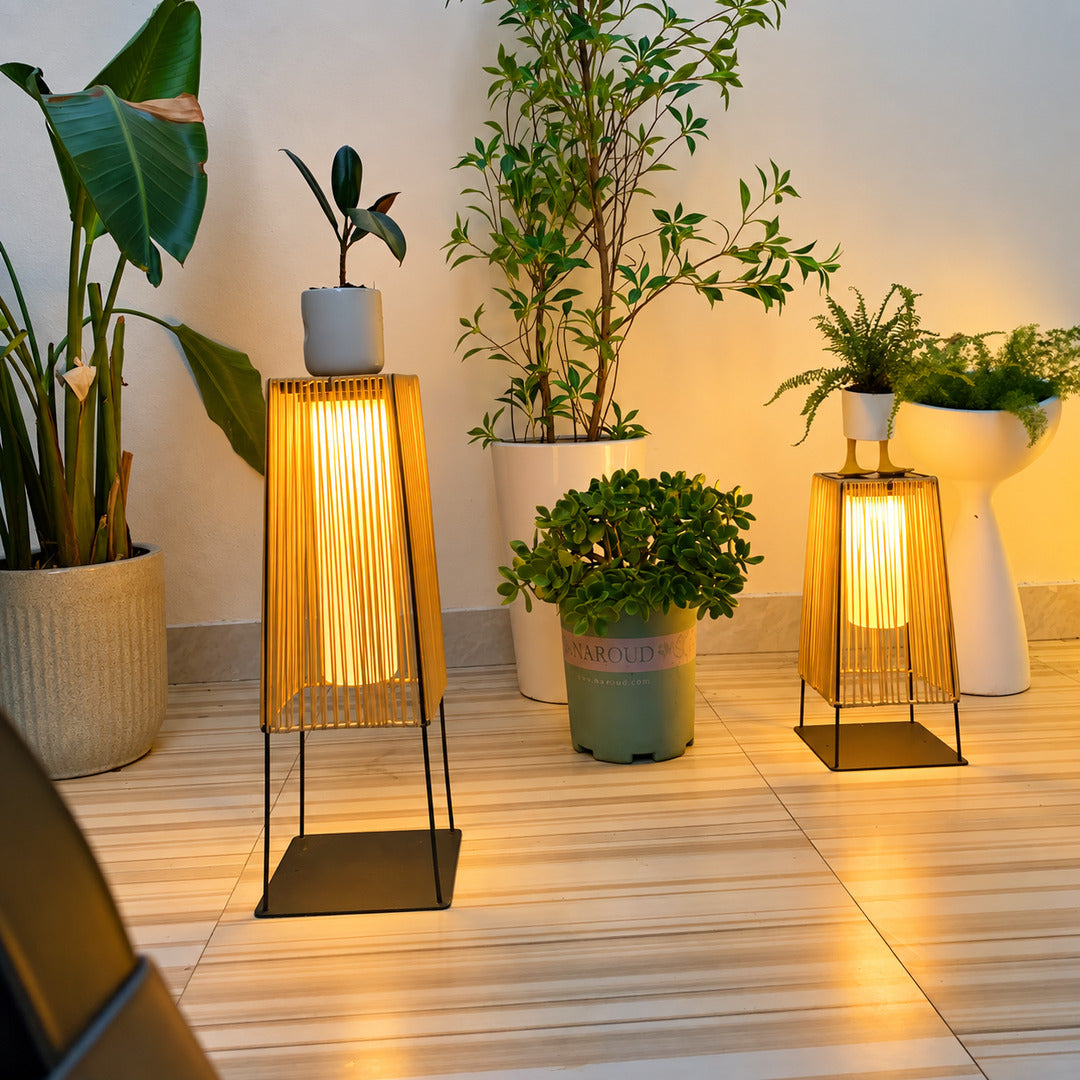 Tall Intreccio outdoor post light standing as a floor lantern on a backyard deck