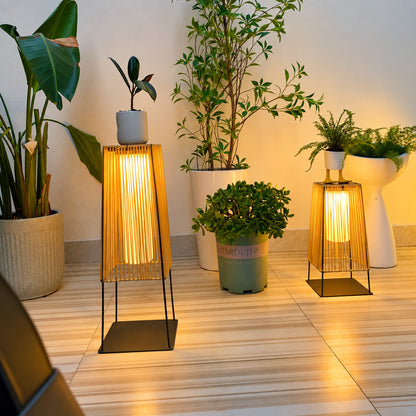 Tall Intreccio outdoor post light standing as a floor lantern on a backyard deck