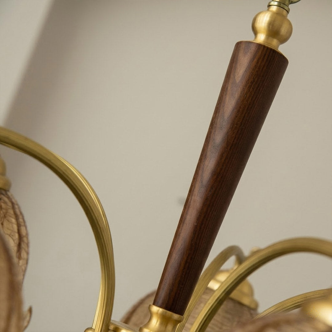 Iris chandelier wood accent at metal arm joint close up natural warmth detail craftsmanship transitional design