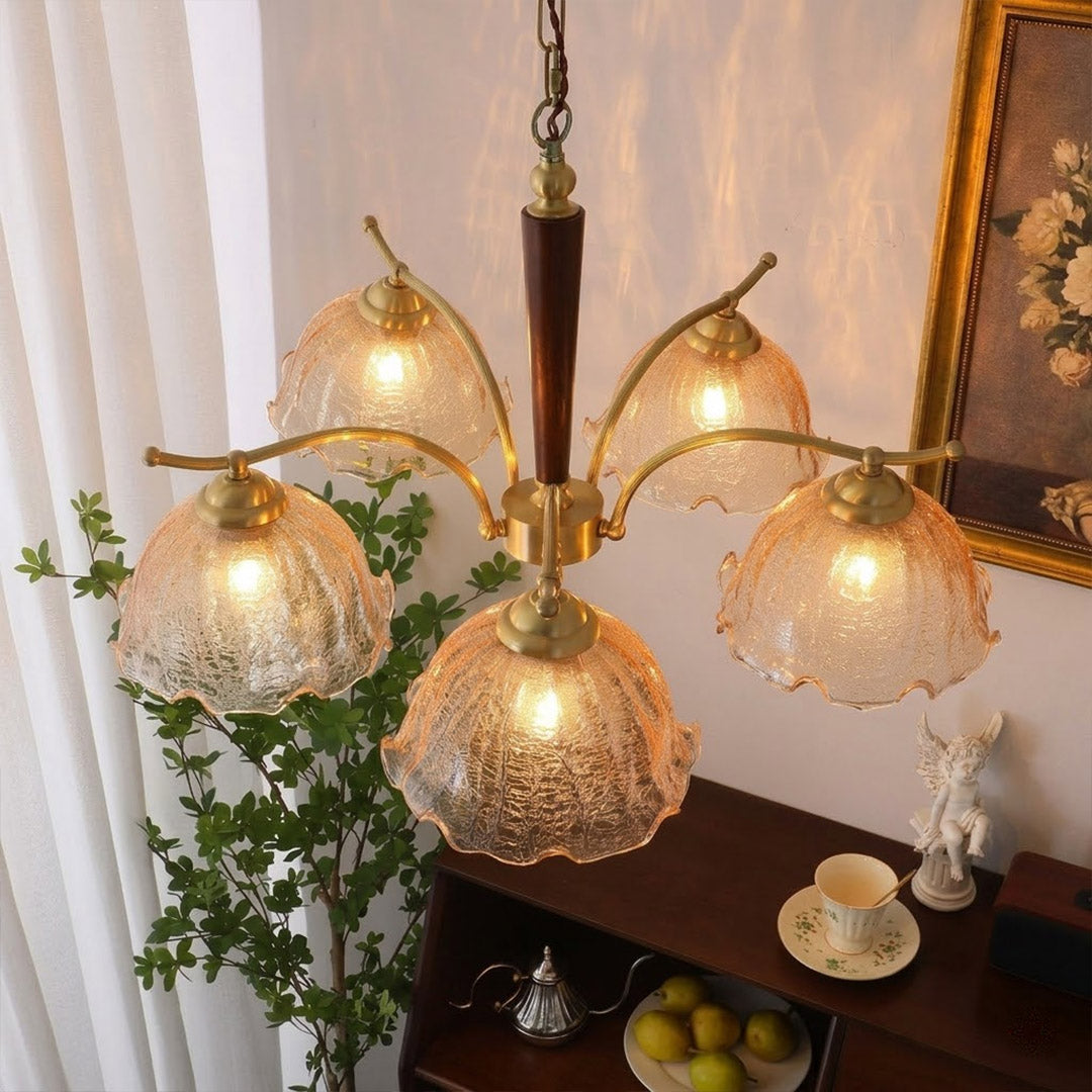 Iris rippled glass shade close up illuminated warm amber glow Edison filament bulb visible refraction texture detail
