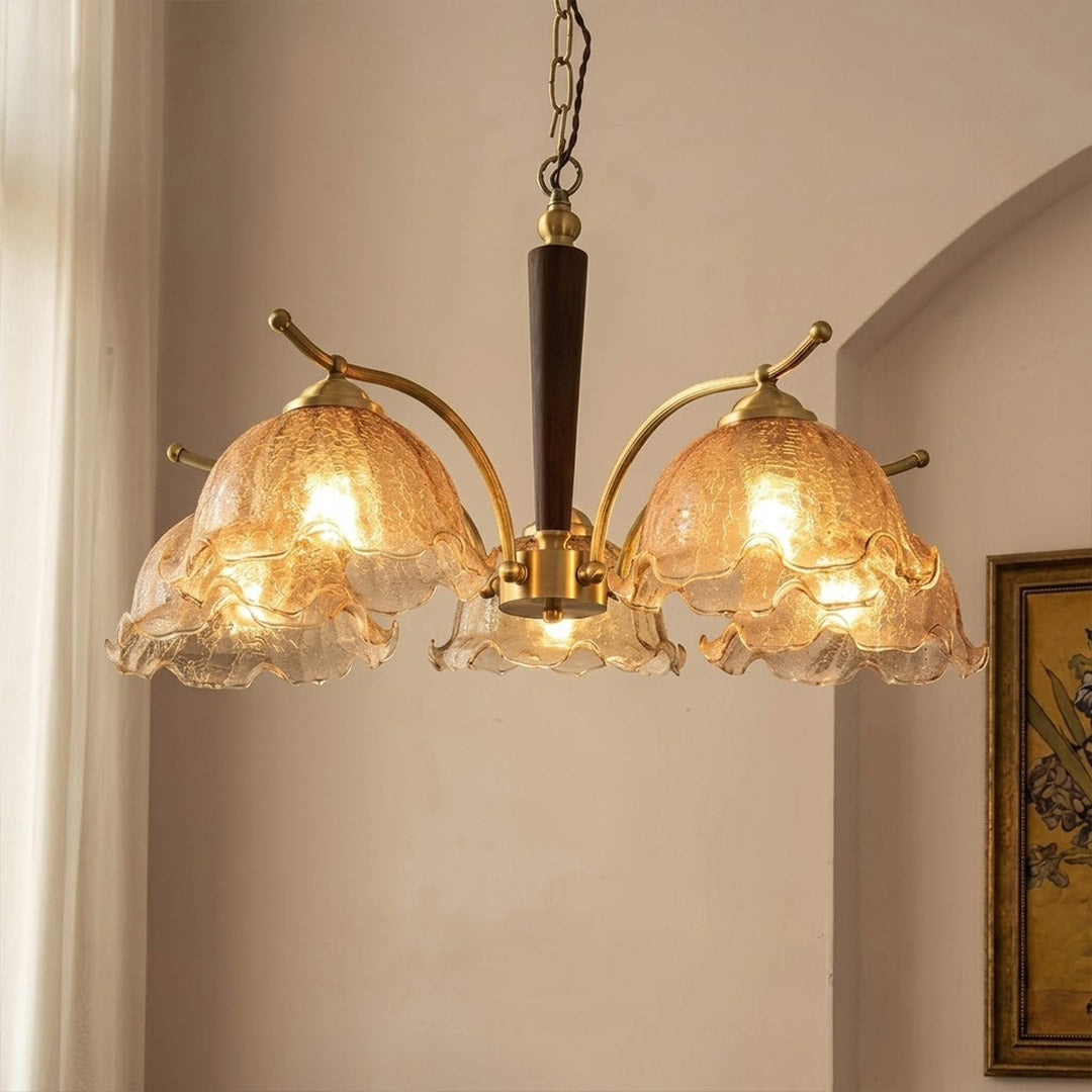 Iris rippled glass shade close up illuminated warm amber glow Edison filament bulb visible refraction texture detail
