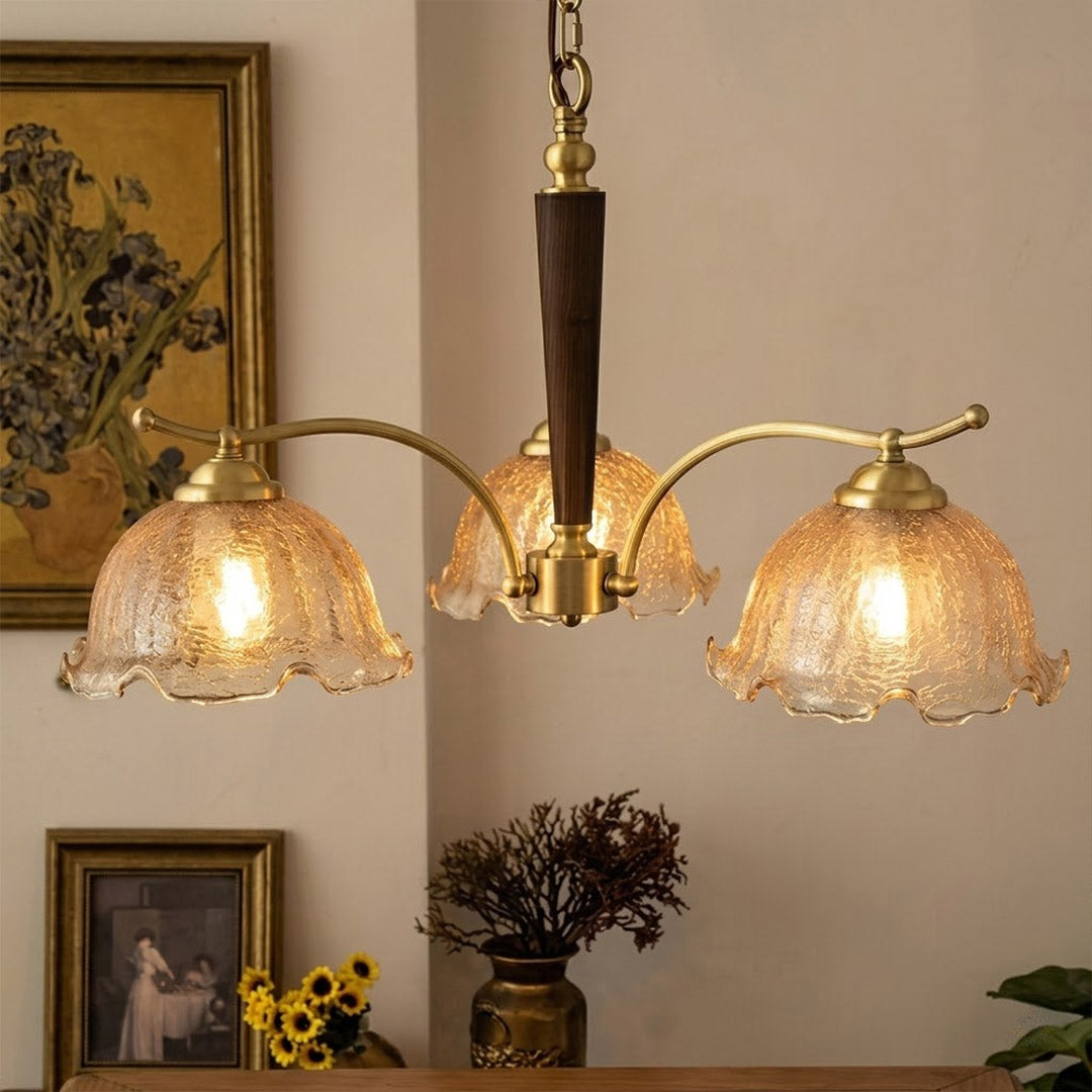 Iris rippled glass shade close up illuminated warm amber glow Edison filament bulb visible refraction texture detail