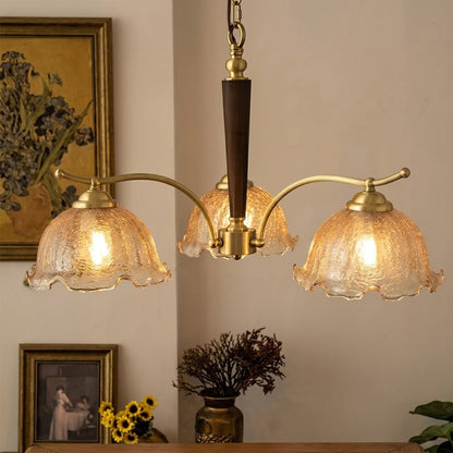Iris rippled glass shade close up illuminated warm amber glow Edison filament bulb visible refraction texture detail