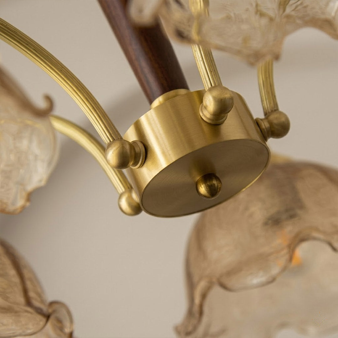 Iris chandelier wood accent at metal arm joint close up natural warmth detail craftsmanship transitional design
