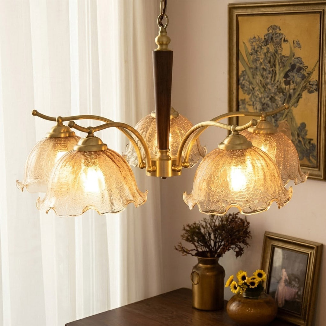 Iris rippled glass shade close up illuminated warm amber glow Edison filament bulb visible refraction texture detail