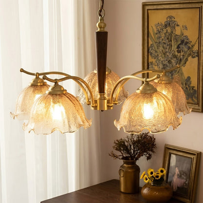 Iris rippled glass shade close up illuminated warm amber glow Edison filament bulb visible refraction texture detail
