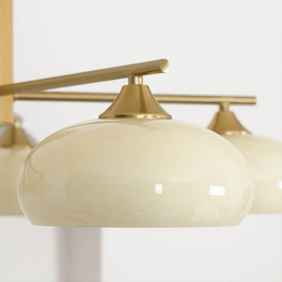Juno chandelier brass arm rounded glass shade detail close up