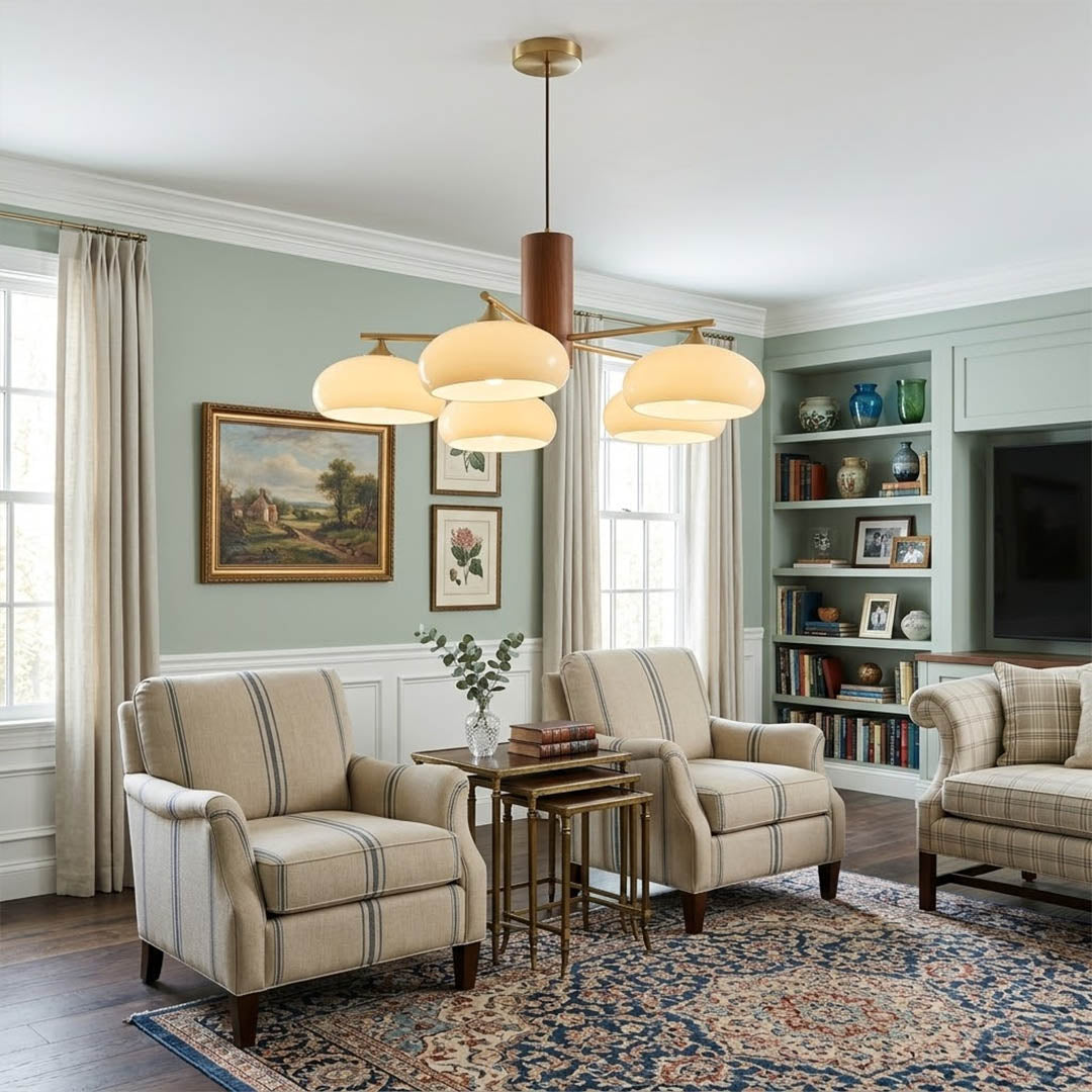 Juno brass chandelier above dining table warm glow glass shades elegant interior