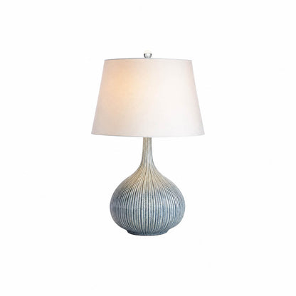 Kova ceramic table lamp small blue ceramic body white fabric shade sculptural modern white background front view