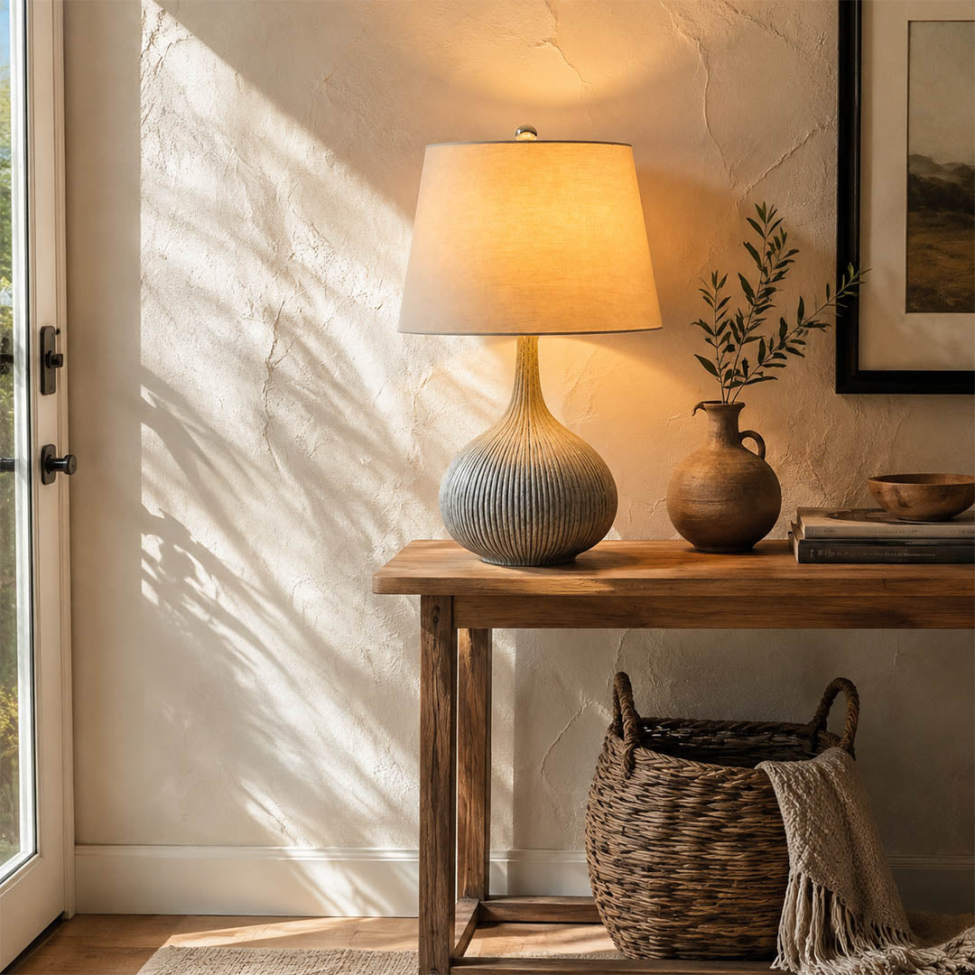 Kova ceramic table lamp illuminated evening blue ceramic white shade warm glowing diffused cozy American home lifestyle interior