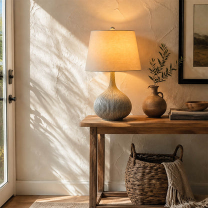 Kova ceramic table lamp illuminated evening blue ceramic white shade warm glowing diffused cozy American home lifestyle interior
