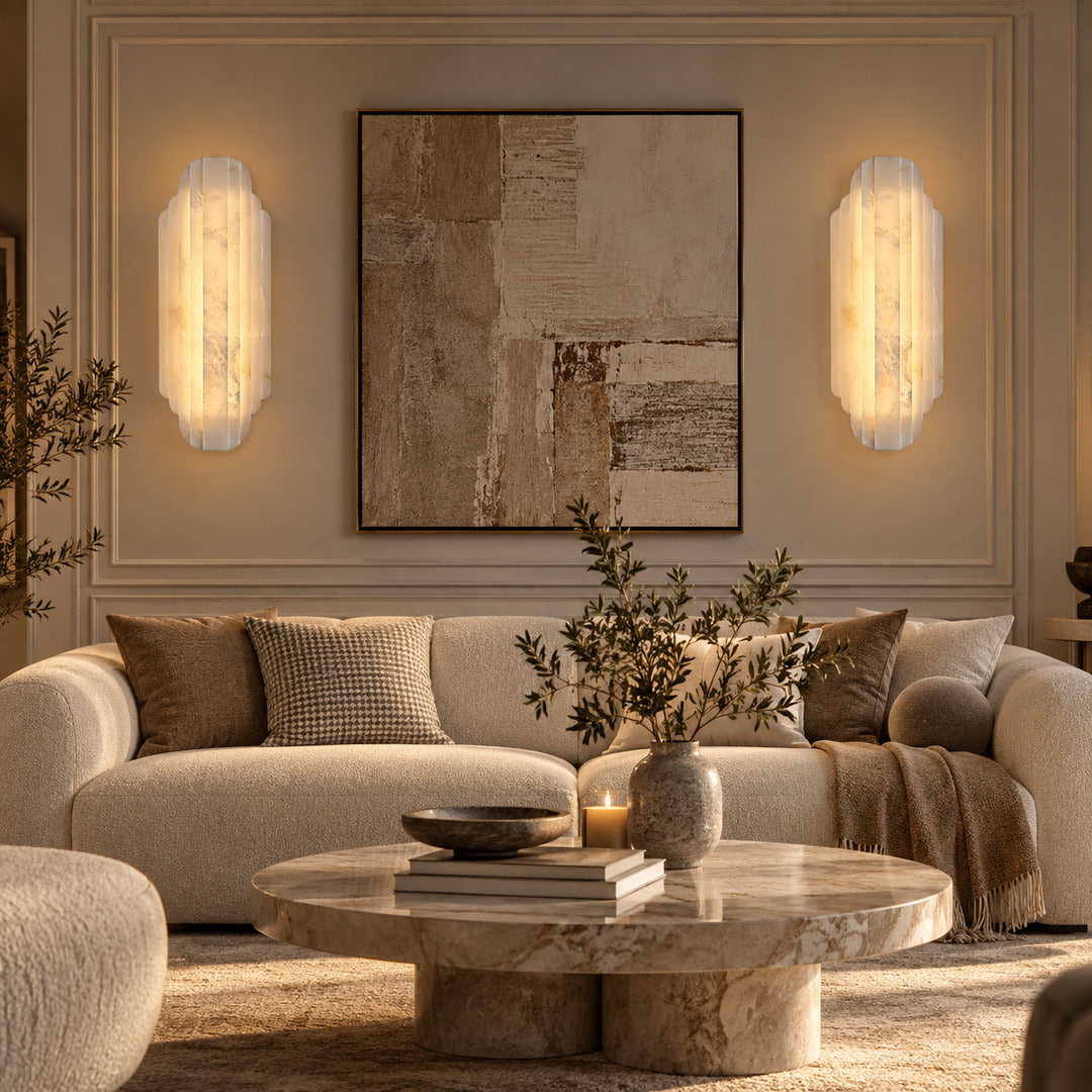 Pair of Lamina alabaster wall sconces above a sofa in a modern living room