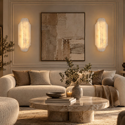 Pair of Lamina alabaster wall sconces above a sofa in a modern living room