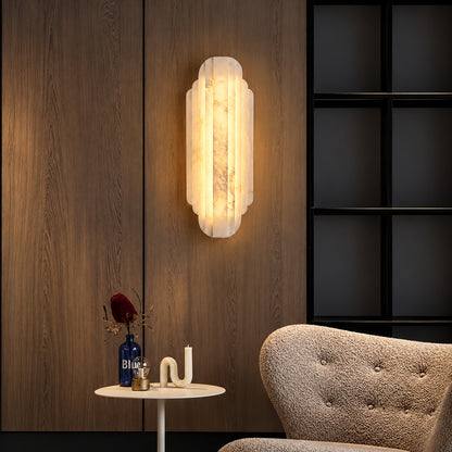 Pair of Lamina alabaster wall sconces above a sofa in a modern living room