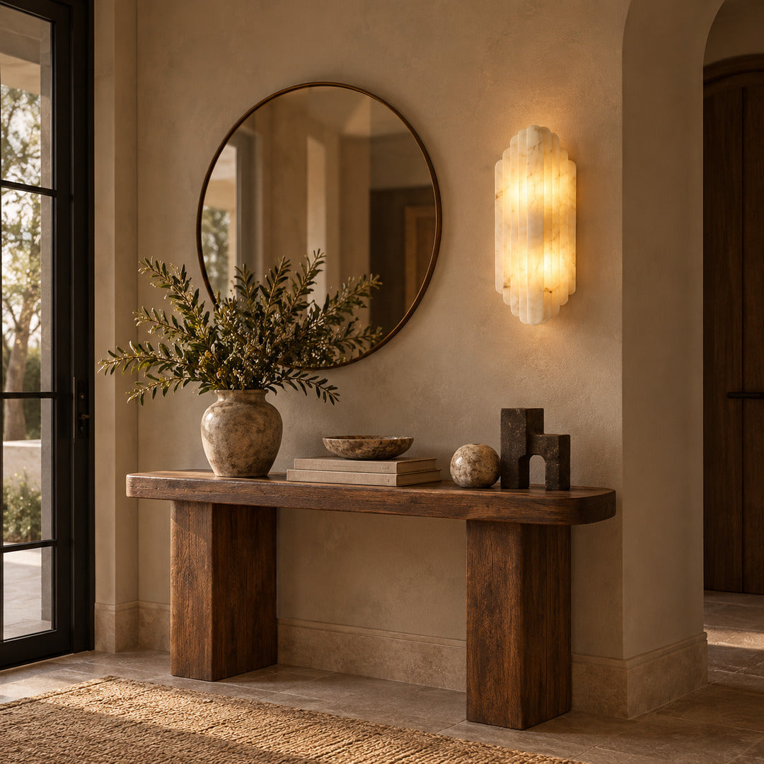 Lamina alabaster wall sconce beside a mirror in an entryway