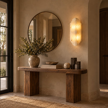 Lamina alabaster wall sconce beside a mirror in an entryway