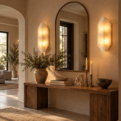 Lamina alabaster wall sconce beside a mirror in an entryway