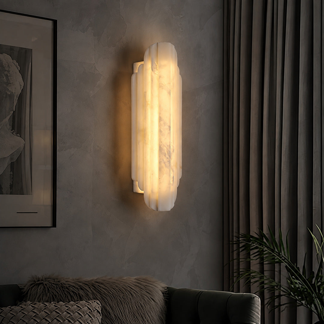 Pair of Lamina alabaster wall sconces above a sofa in a modern living room