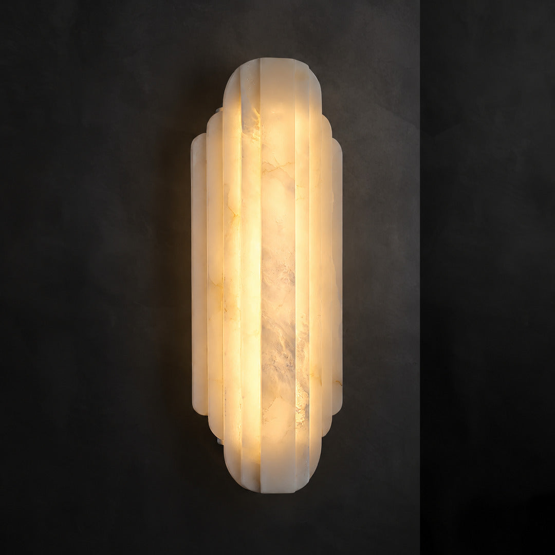 Close-up of natural veining glowing through the layered alabaster discs of the Lamina wall sconce