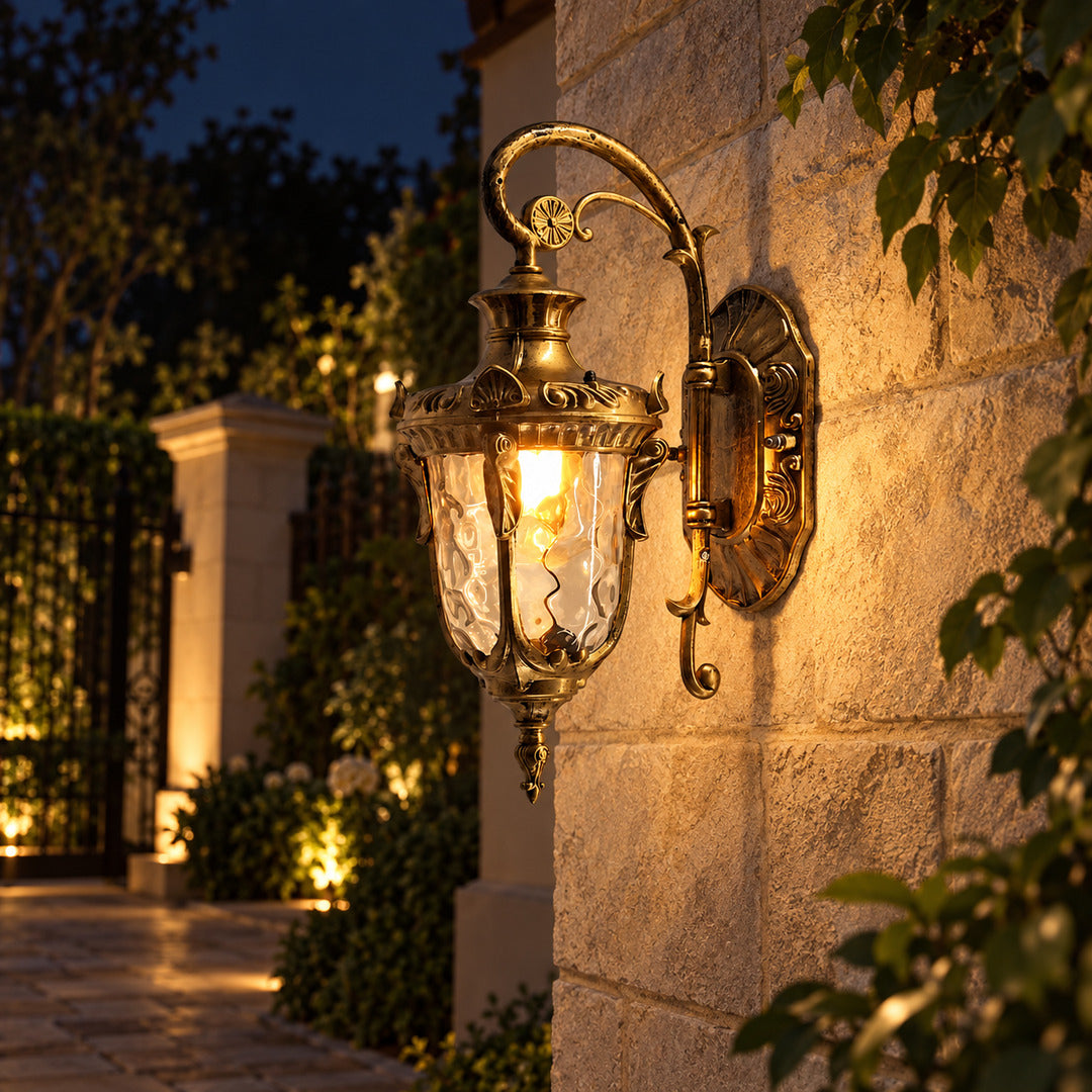 Lanterna outdoor wall sconce lighting a garden wall with a soft warm glow at dusk