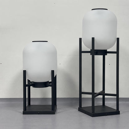 Short and tall Larsen solar powered outdoor lantern floor lamps unlit with white frosted shades.