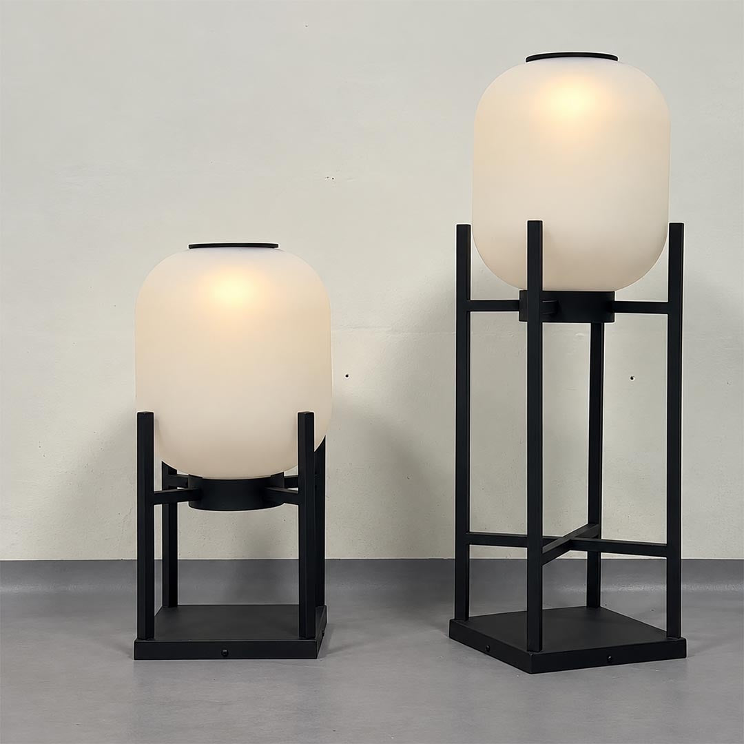 Warm light illuminated short and tall Larsen solar outdoor lantern floor lamps by stuberlighting.