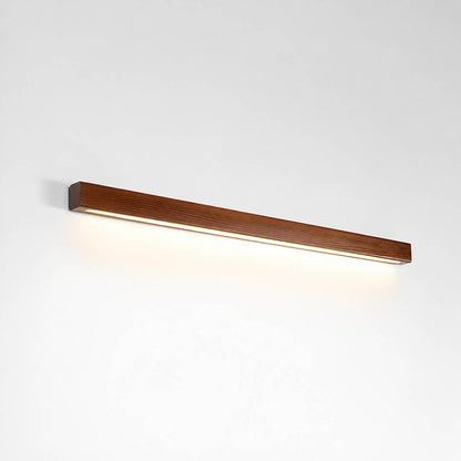 Larsson linear wood wall light walnut color wood integrated LED warm glow slim linear bar white background front view