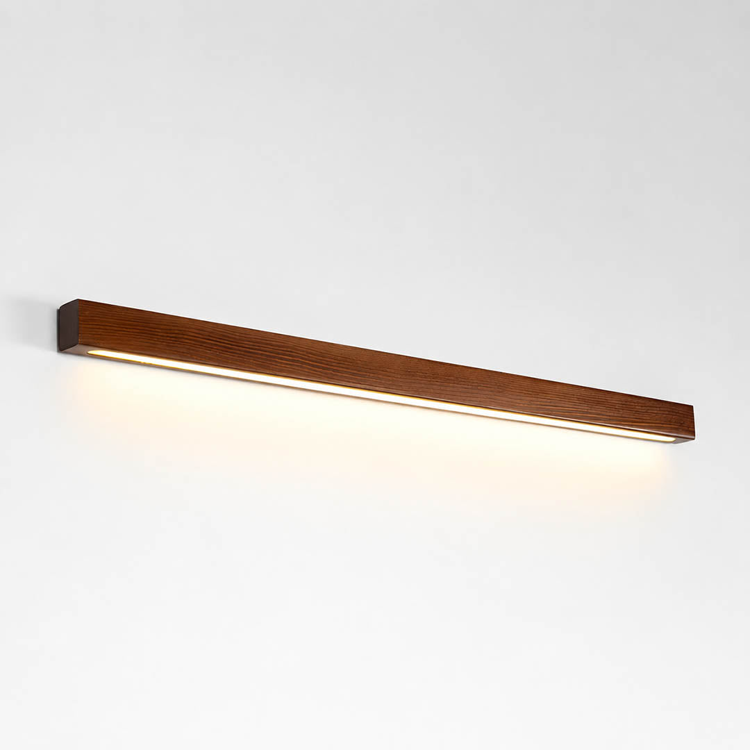 Larsson linear wood wall light walnut color wood integrated LED warm glow slim linear bar white background front view